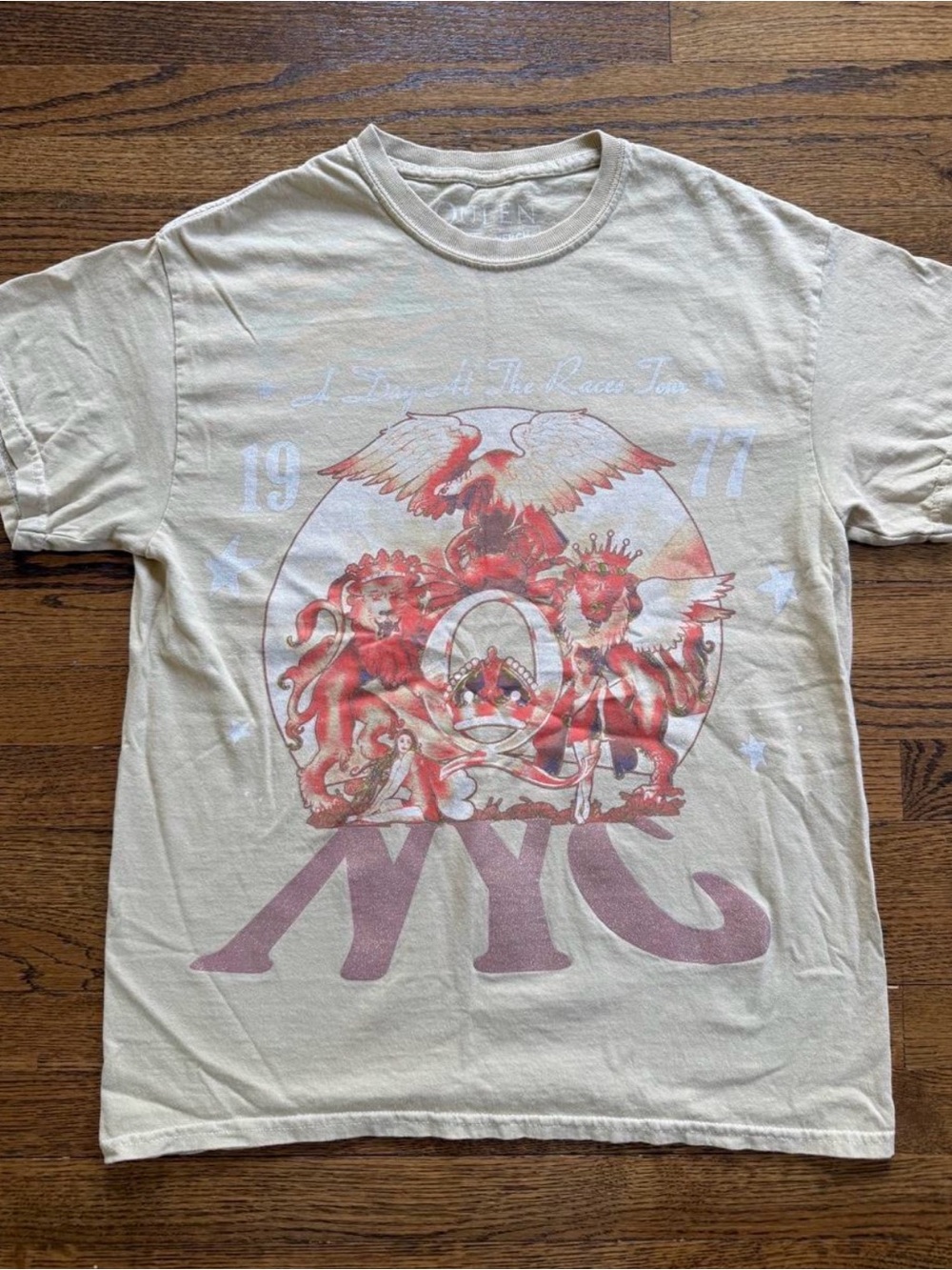 Queen Official Merch Cream Short Sleeve Tee with Red and Pink NYC Crest Graphic